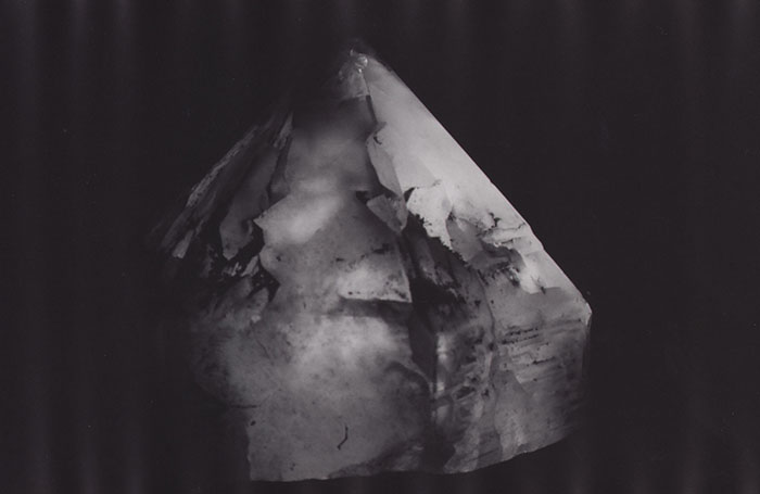 A conical crystal lamp on a black backdrop